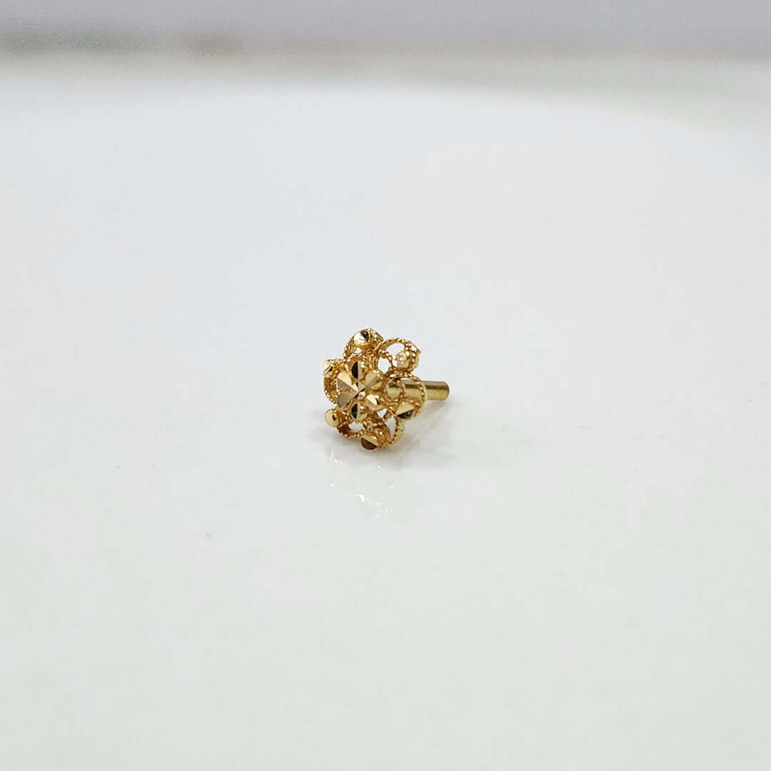 Radiant Filigree gold nose pin 18K angled view with intricate floral filigree design on plain background