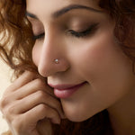 Woman wearing simple gold nose pin close-up portrait