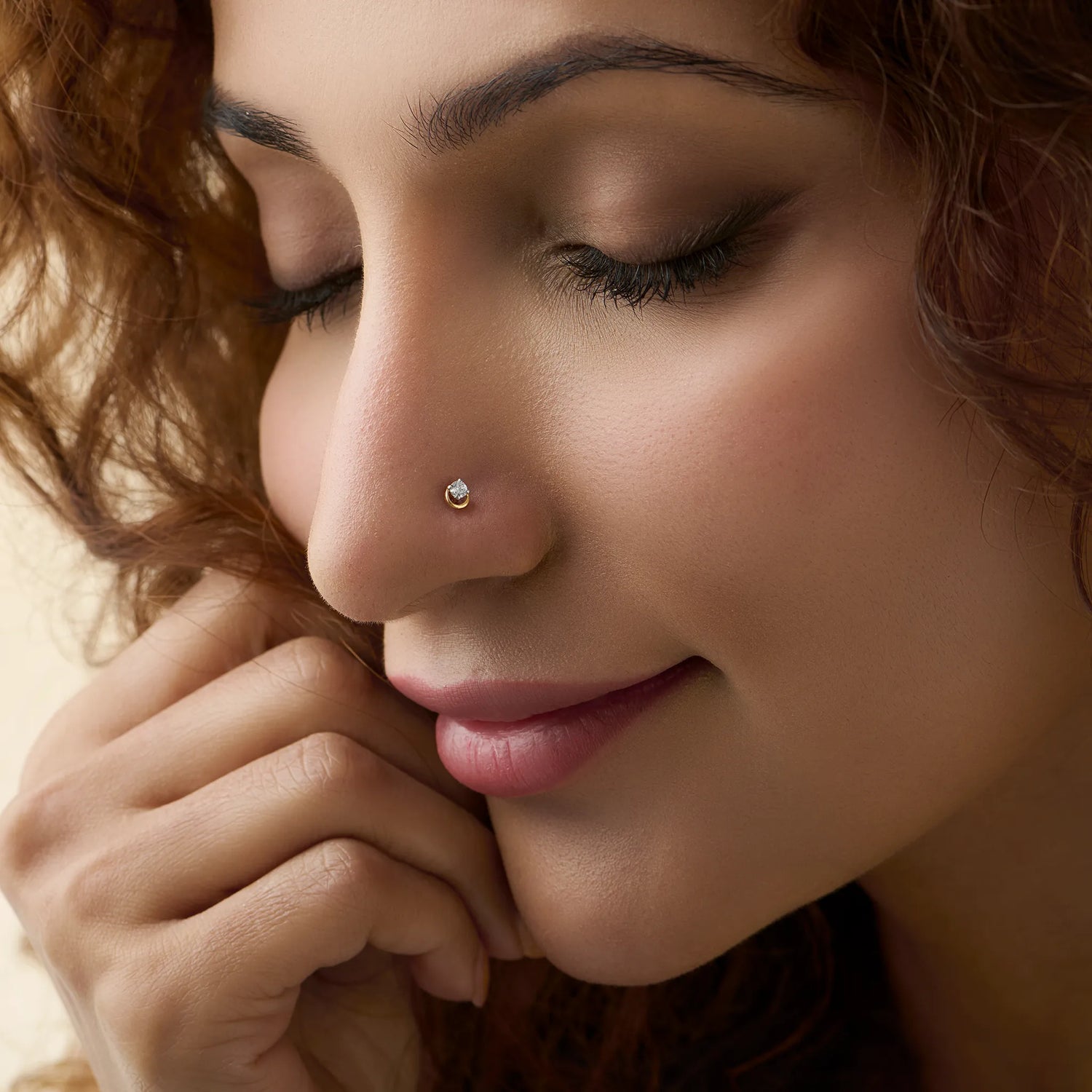 Woman wearing simple gold nose pin close-up portrait