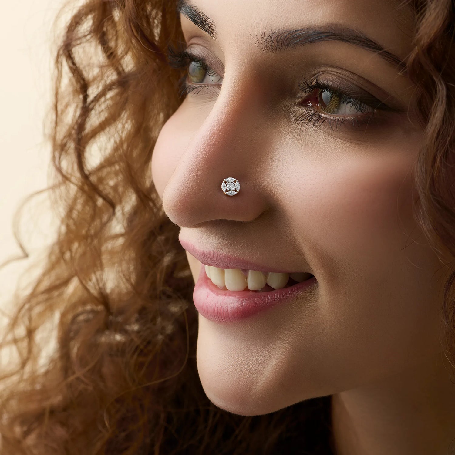 Round floral cluster gold nose pins with marquise and round diamonds on soft background