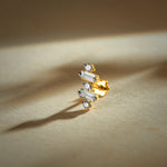 Nose pin gold with modern geometric design featuring baguette and round sparkling stones set in a polished gold base on a soft neutral background