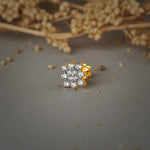 Nose pin gold with floral cluster design featuring multiple sparkling stones set in a polished gold base on a soft neutral background
