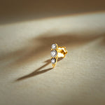 Nose pin gold with triple stone design featuring three sparkling stones set in a sleek gold base on a soft neutral background