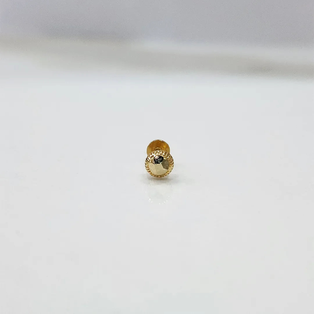 Tiny 18K nose pin gold placed on a white background for clarity