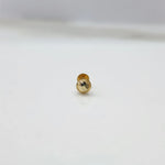 Tiny 18K nose pin gold placed on a white background for clarity