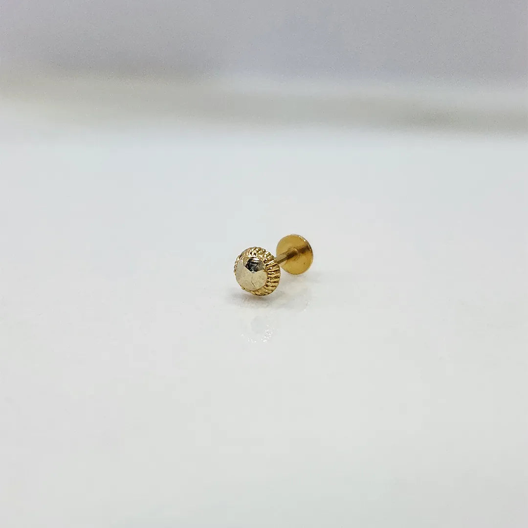 Small 18K nose pin gold on a white surface displaying its detailing