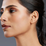 Side profile of a woman wearing a minimal 18K gold nose ring showcasing elegant everyday styling