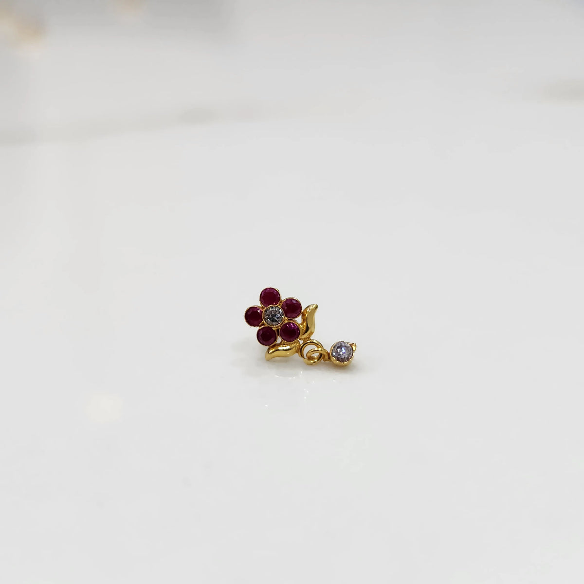 Stone gold nose pin minimal floral style close up