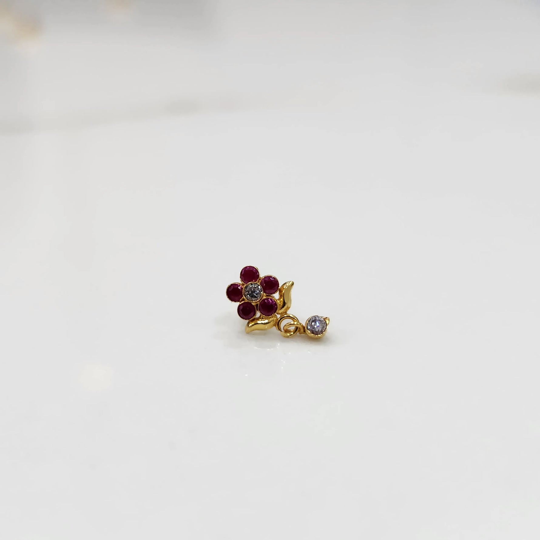 Stone gold nose pin minimal floral style close up
