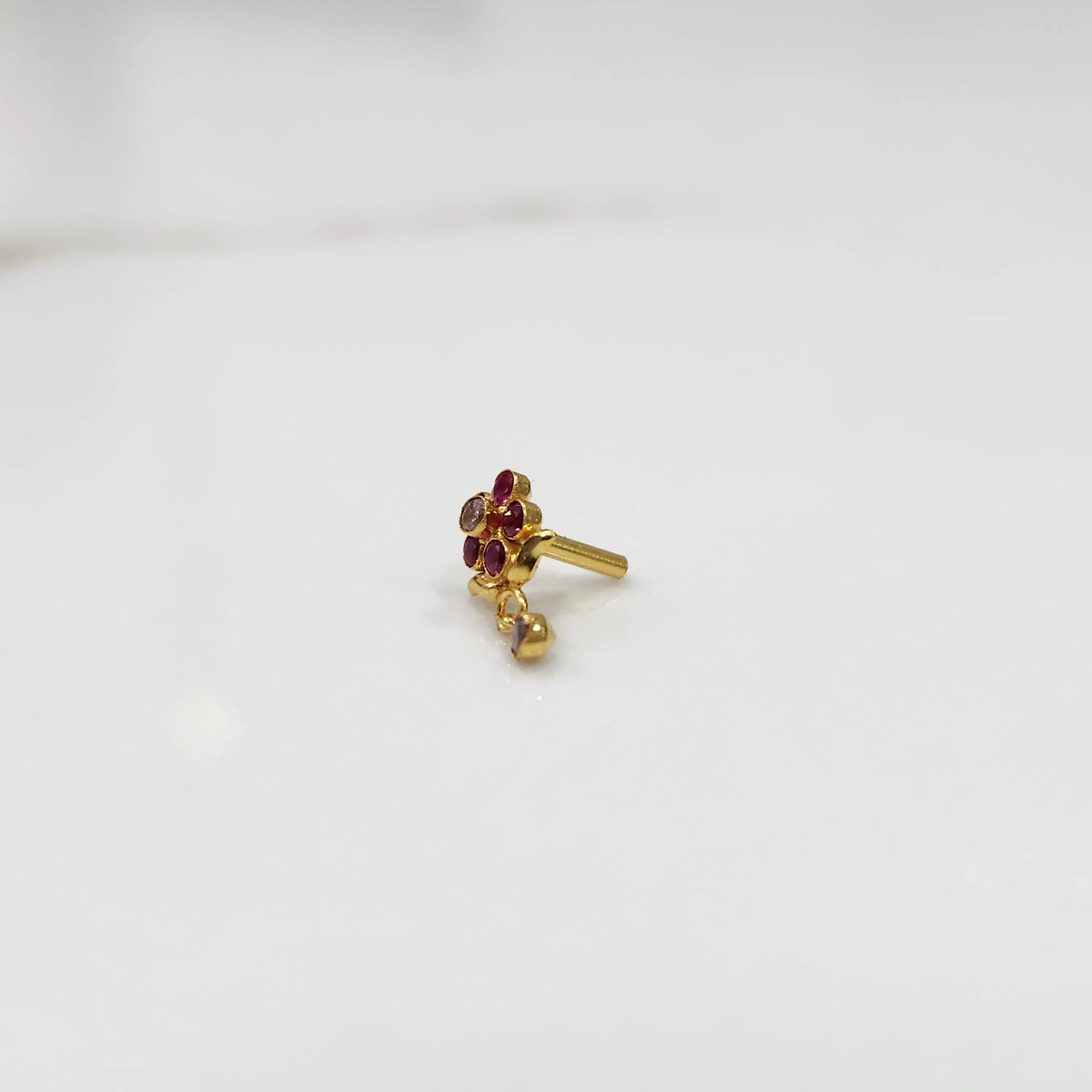 Stone gold nose pin floral design front view on white background