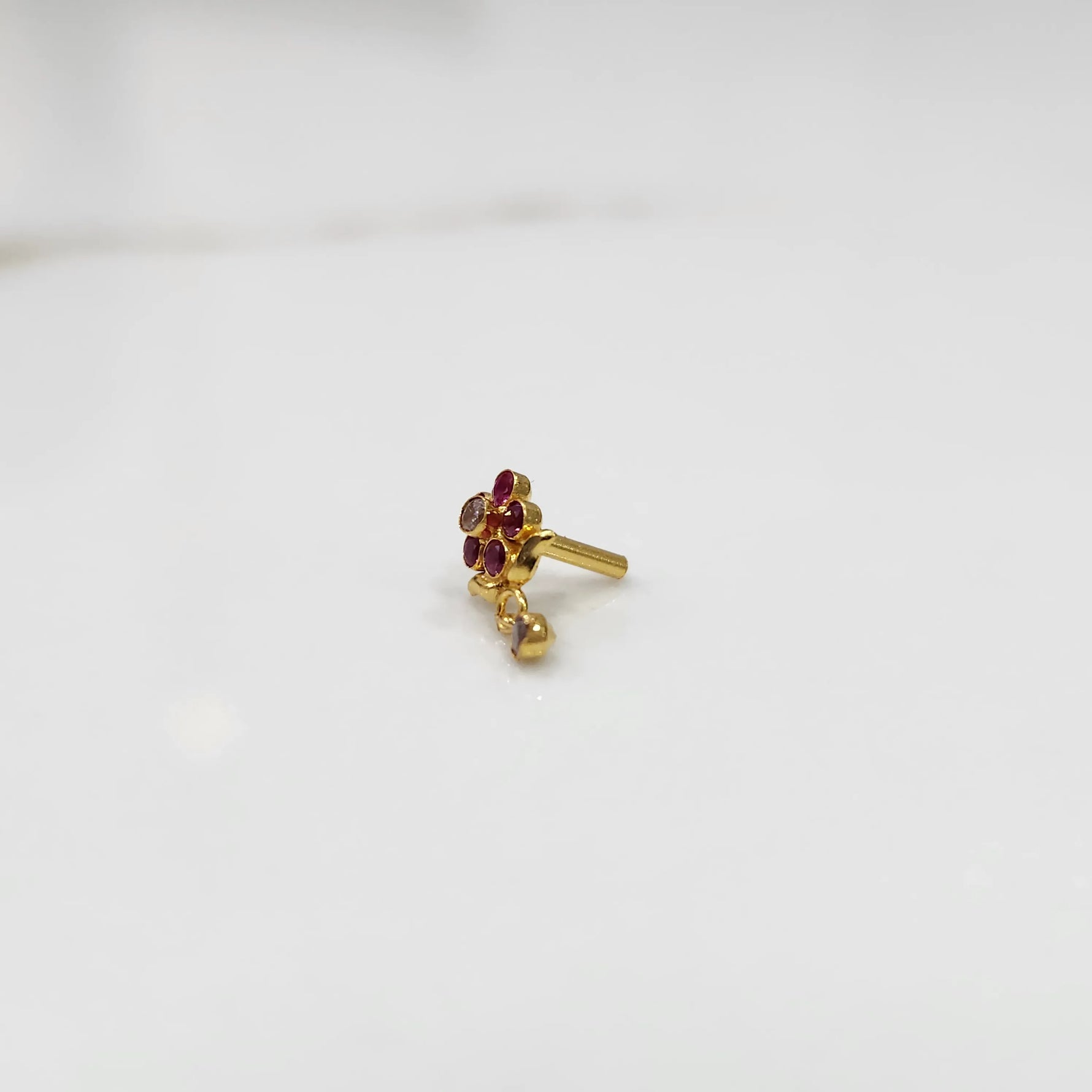 Stone gold nose pin floral design front view on white background