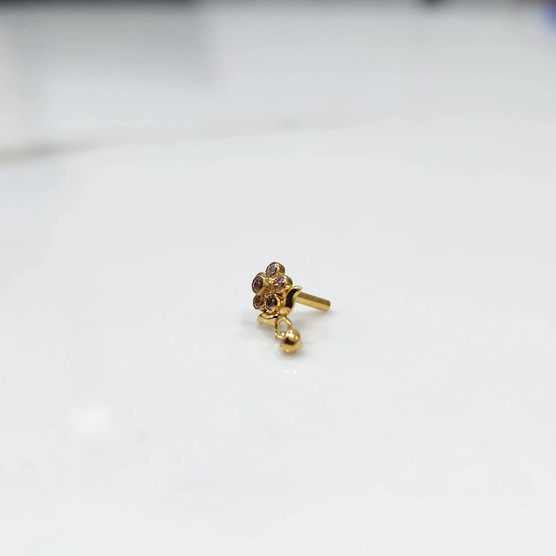 Stone gold nose pin side angle showing post and setting