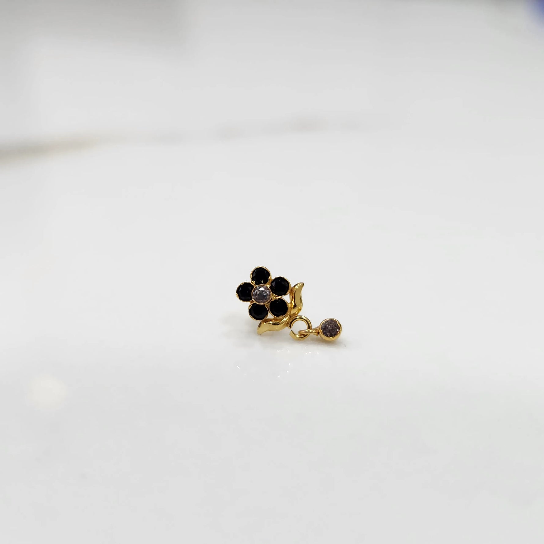 Stone gold nose pin minimal floral style close up