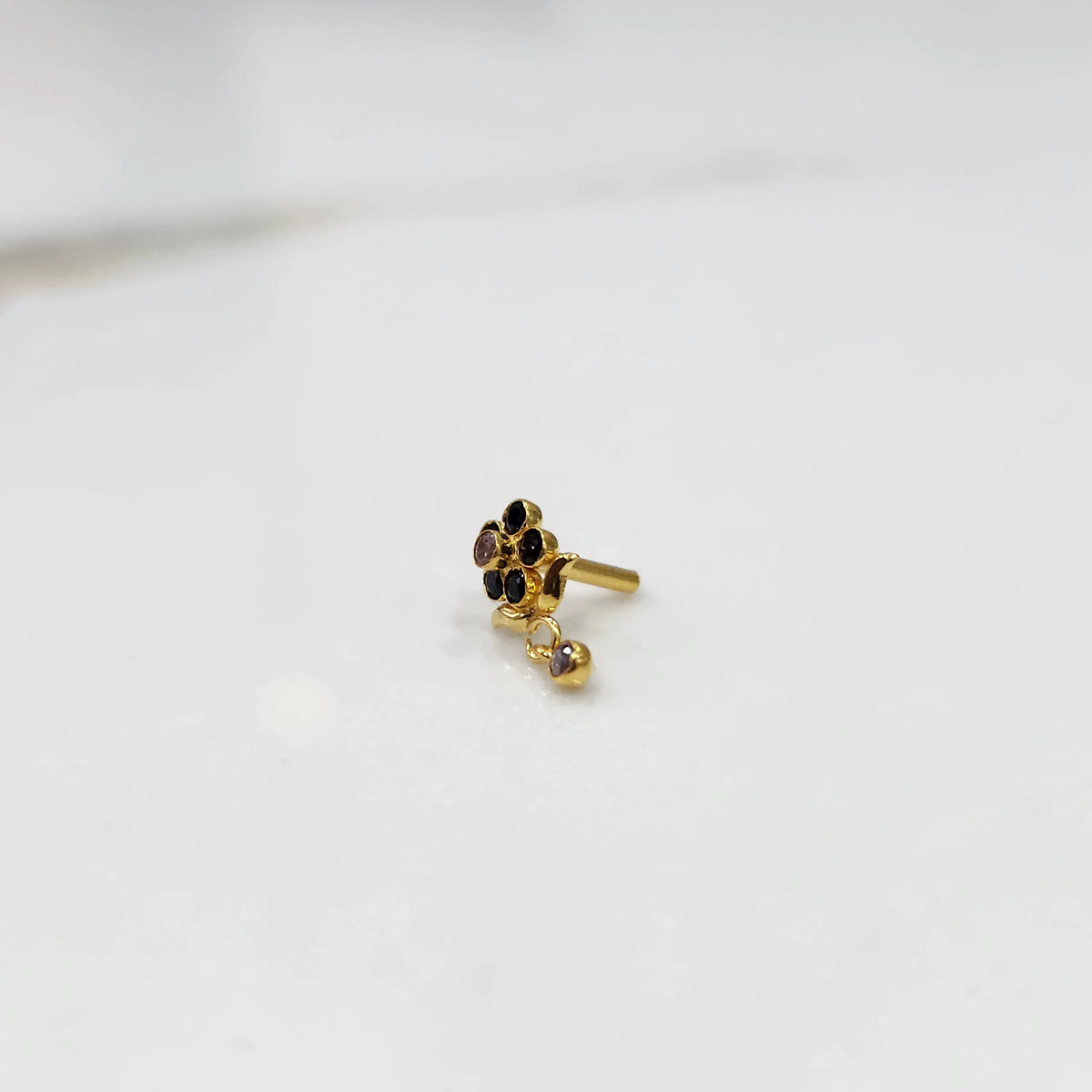 Stone gold nose pin minimal floral style close up