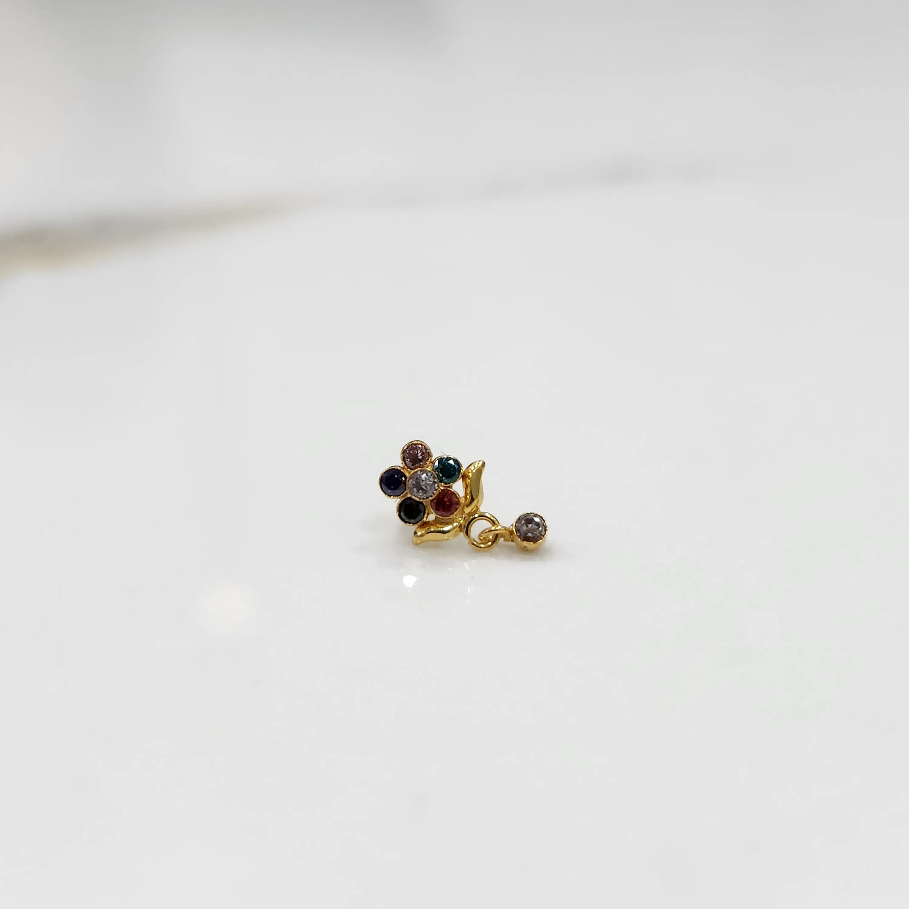 Stone gold nose pin minimal floral style close up