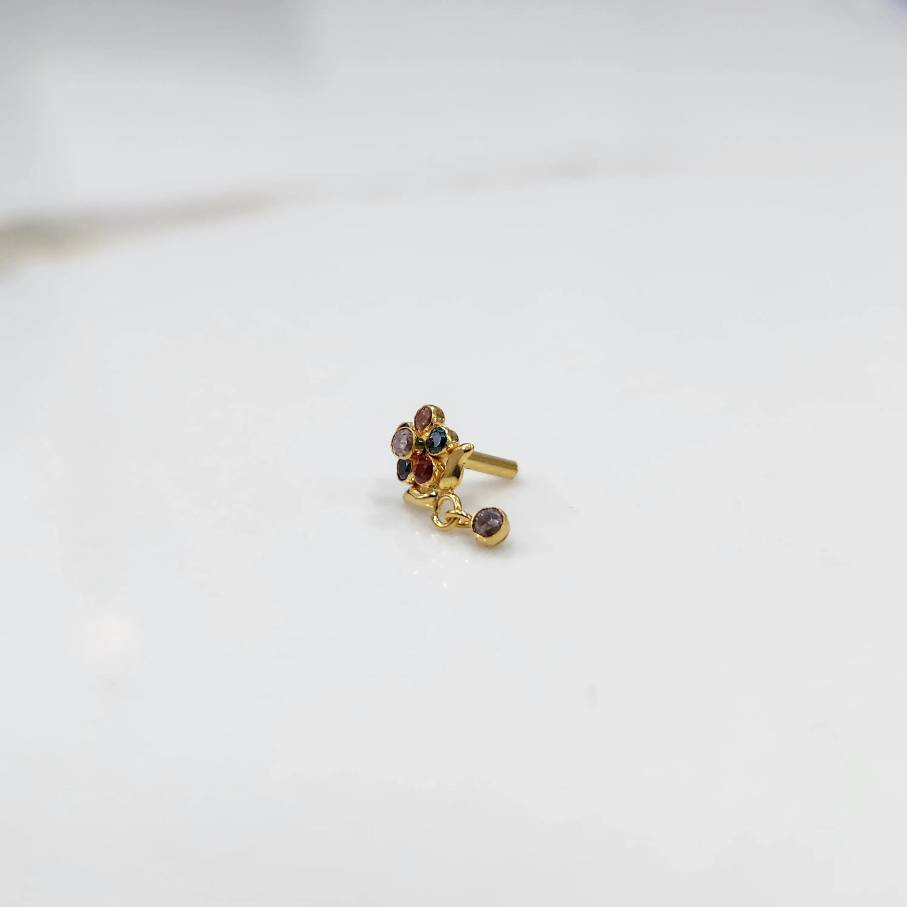 Stone gold nose pin minimal floral style close up
