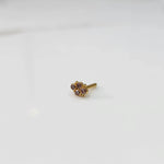 Women's gold nose pin design side view with small gemstone floral design