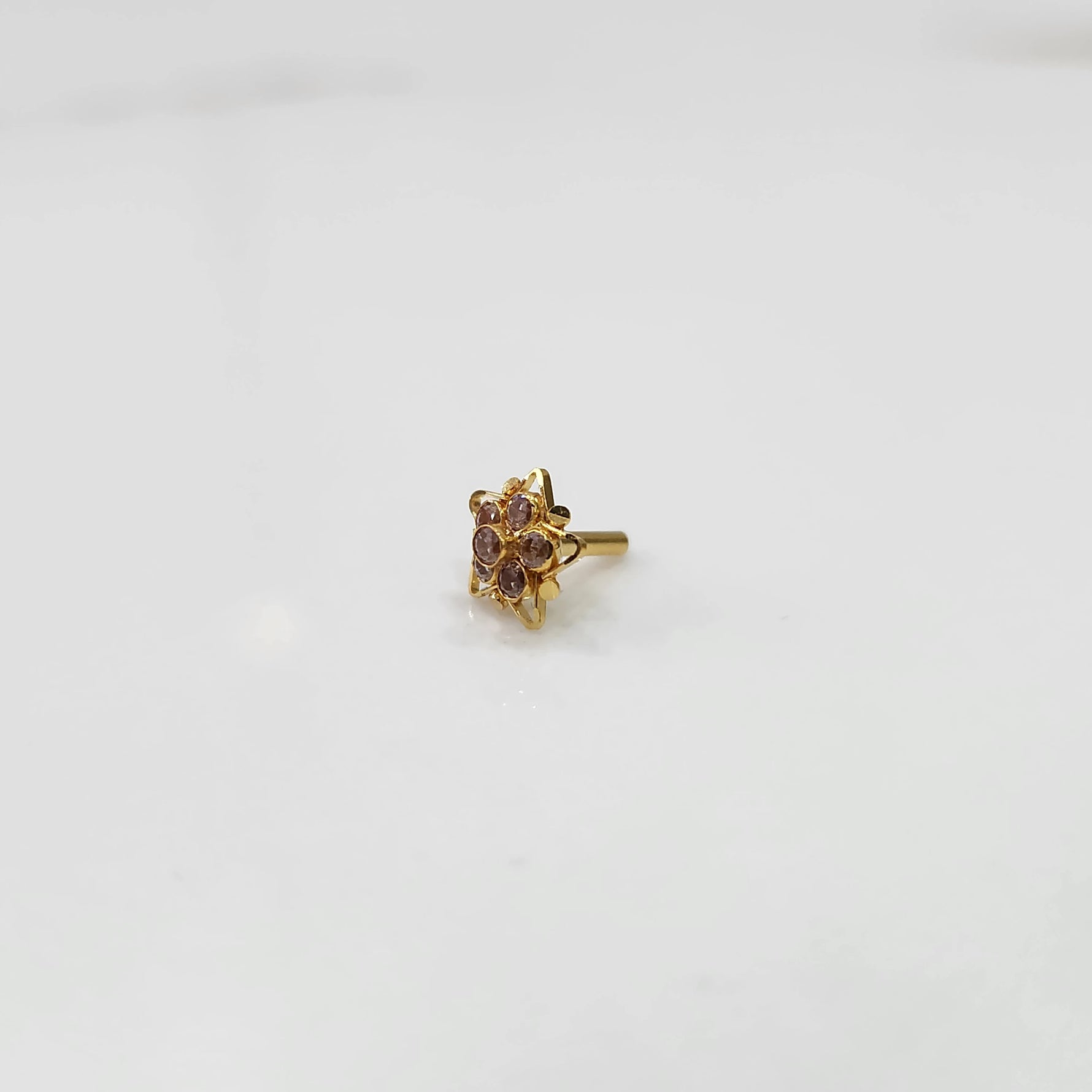 Nose pin design gold with red stone center and floral pattern
