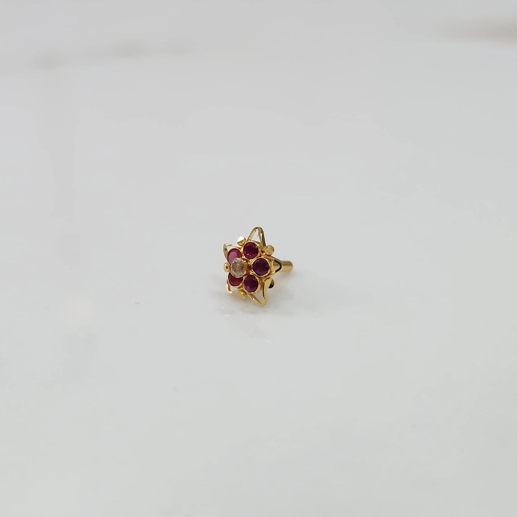 Nose pin design gold with small gemstone cluster elegant style
