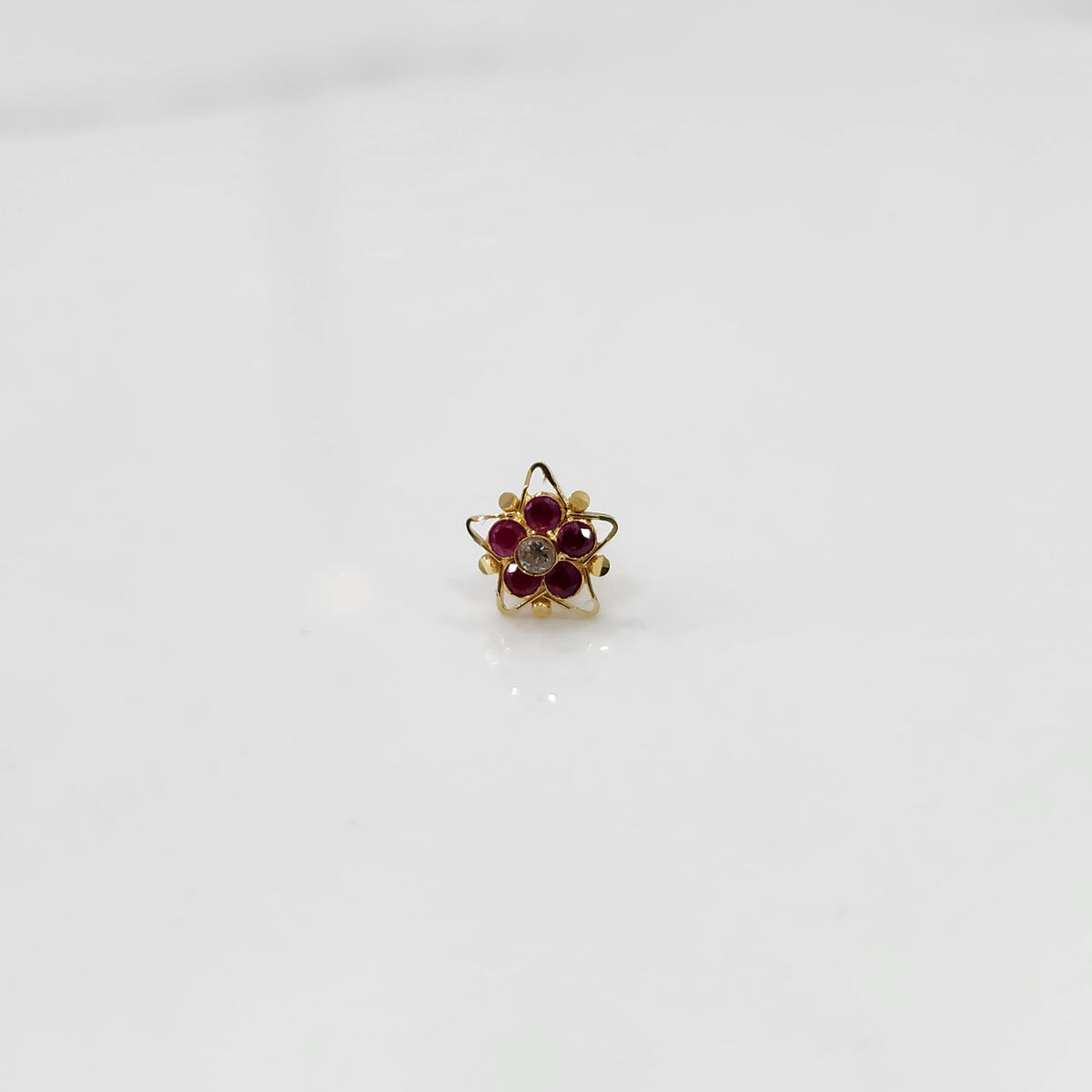 Nose pin design gold with multicolor stones in compact floral design