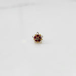 Nose pin design gold with multicolor stones in compact floral design