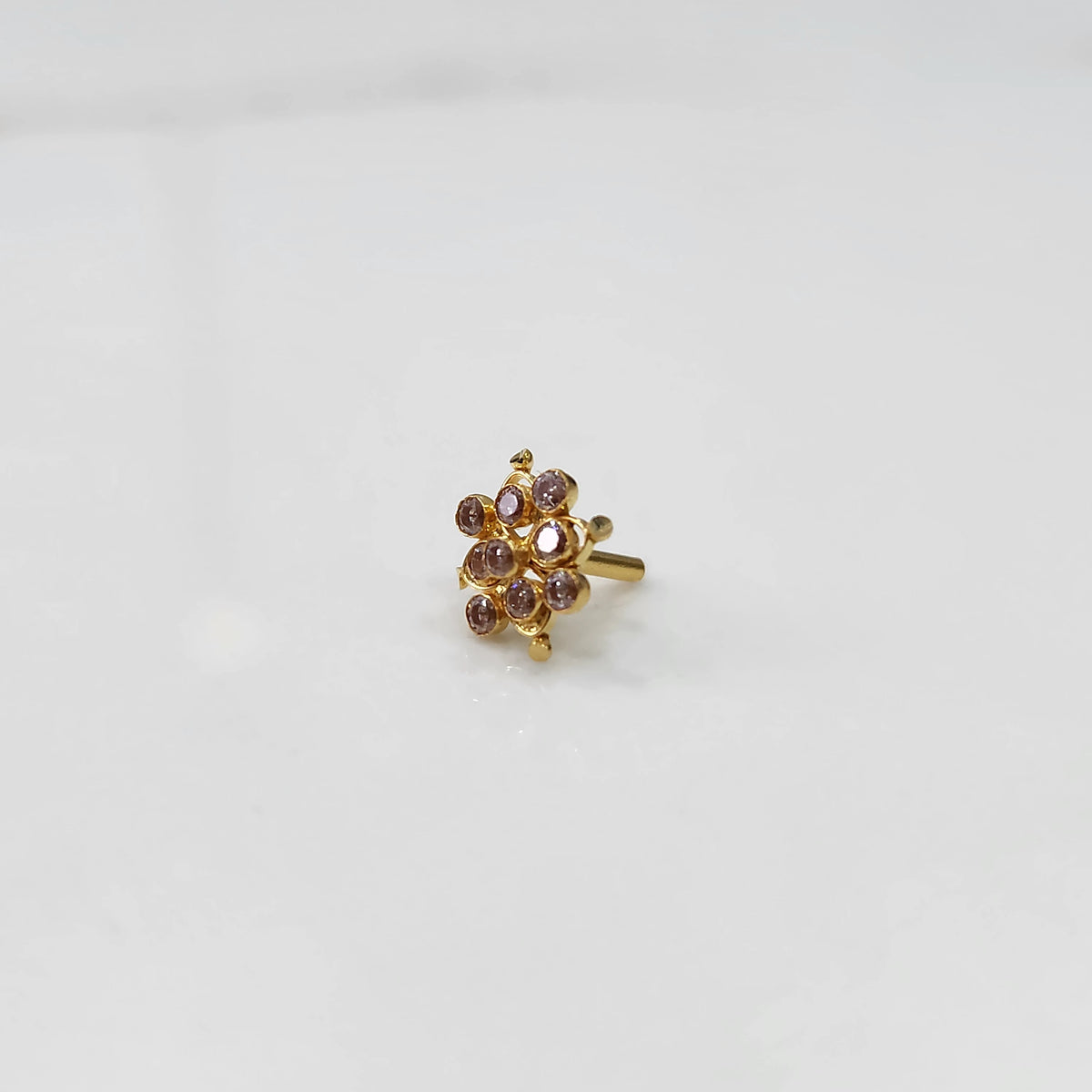 Woman wearing elegant stone gold nose pin with minimal look