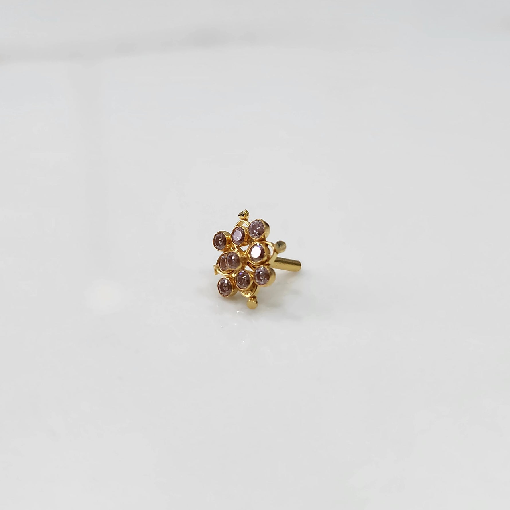 Woman wearing elegant stone gold nose pin with minimal look