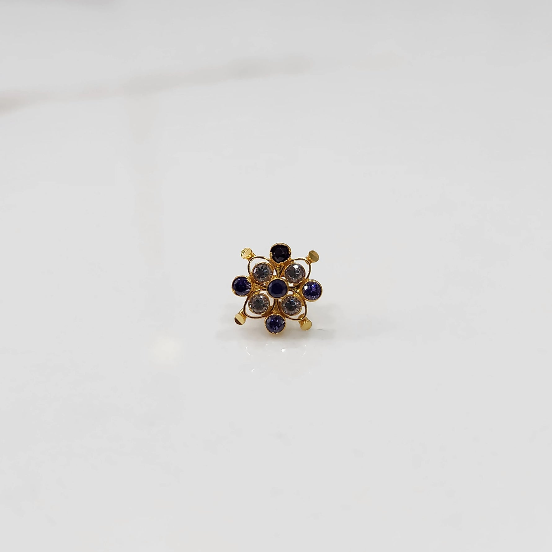 Stone gold nose pin close up with sparkling stones