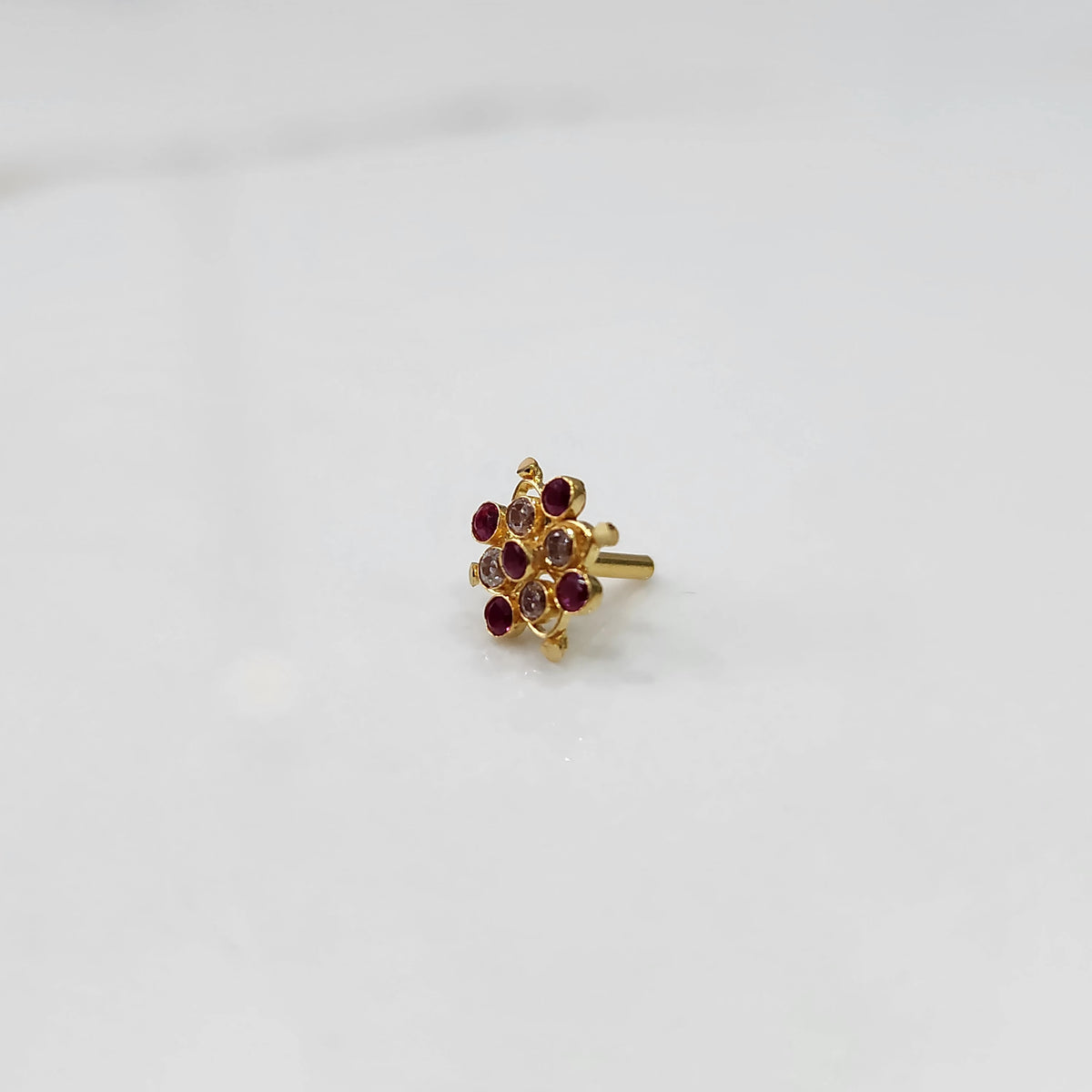 Tiny stone gold nose pin minimal style front view