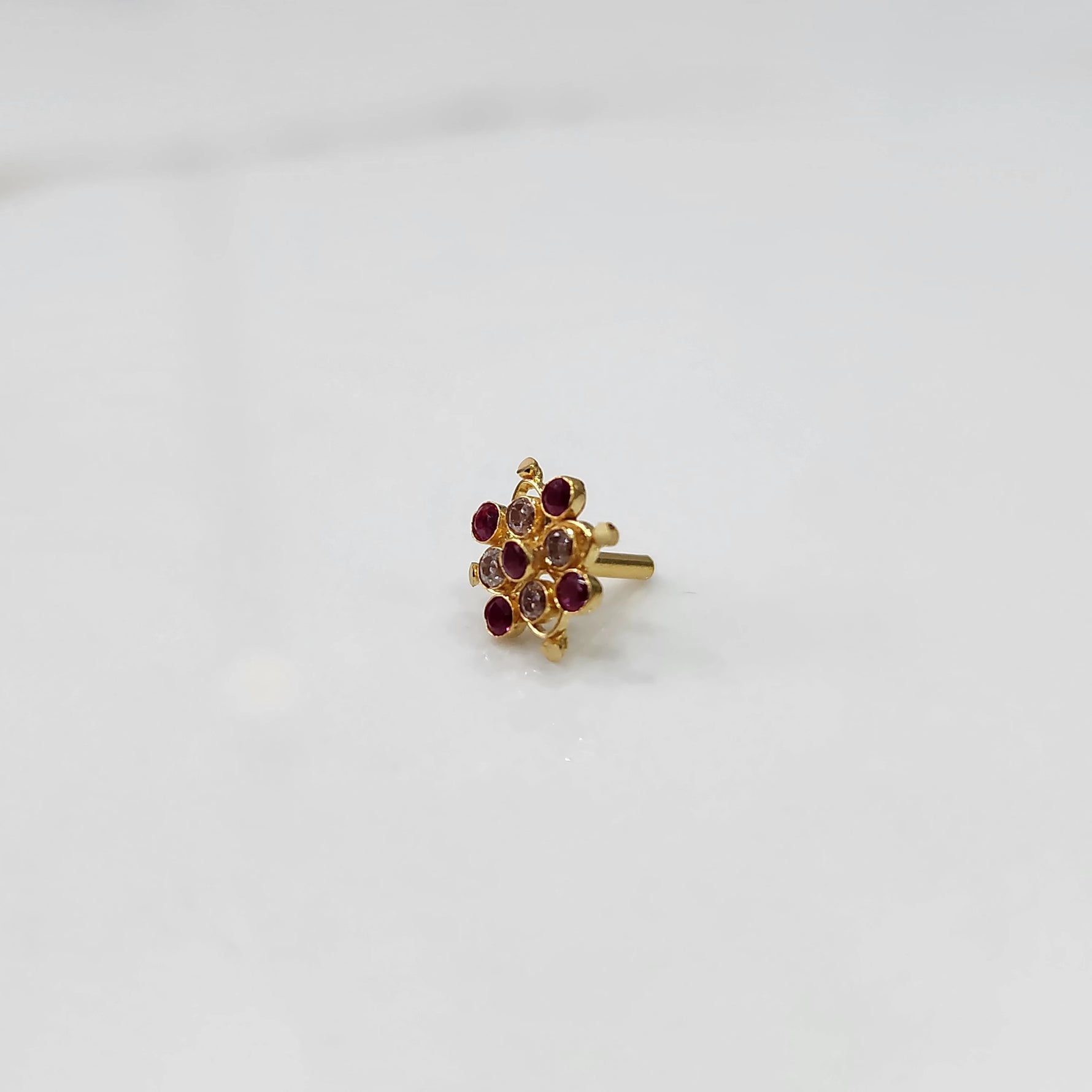 Tiny stone gold nose pin minimal style front view
