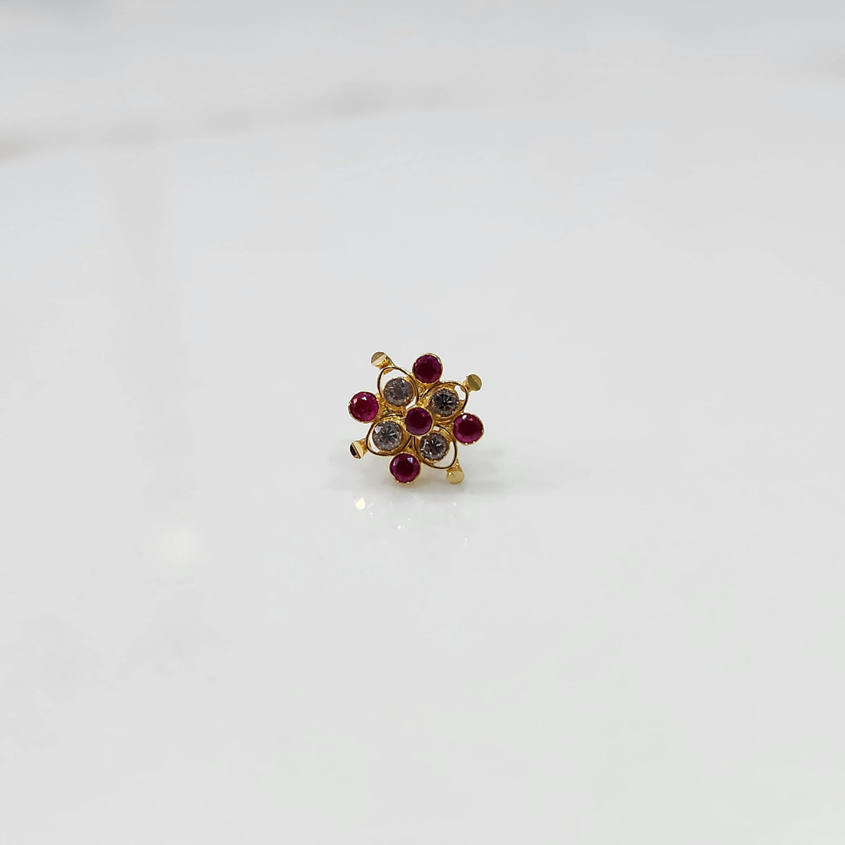 Stone gold nose pin with multicolor stones variation on white background