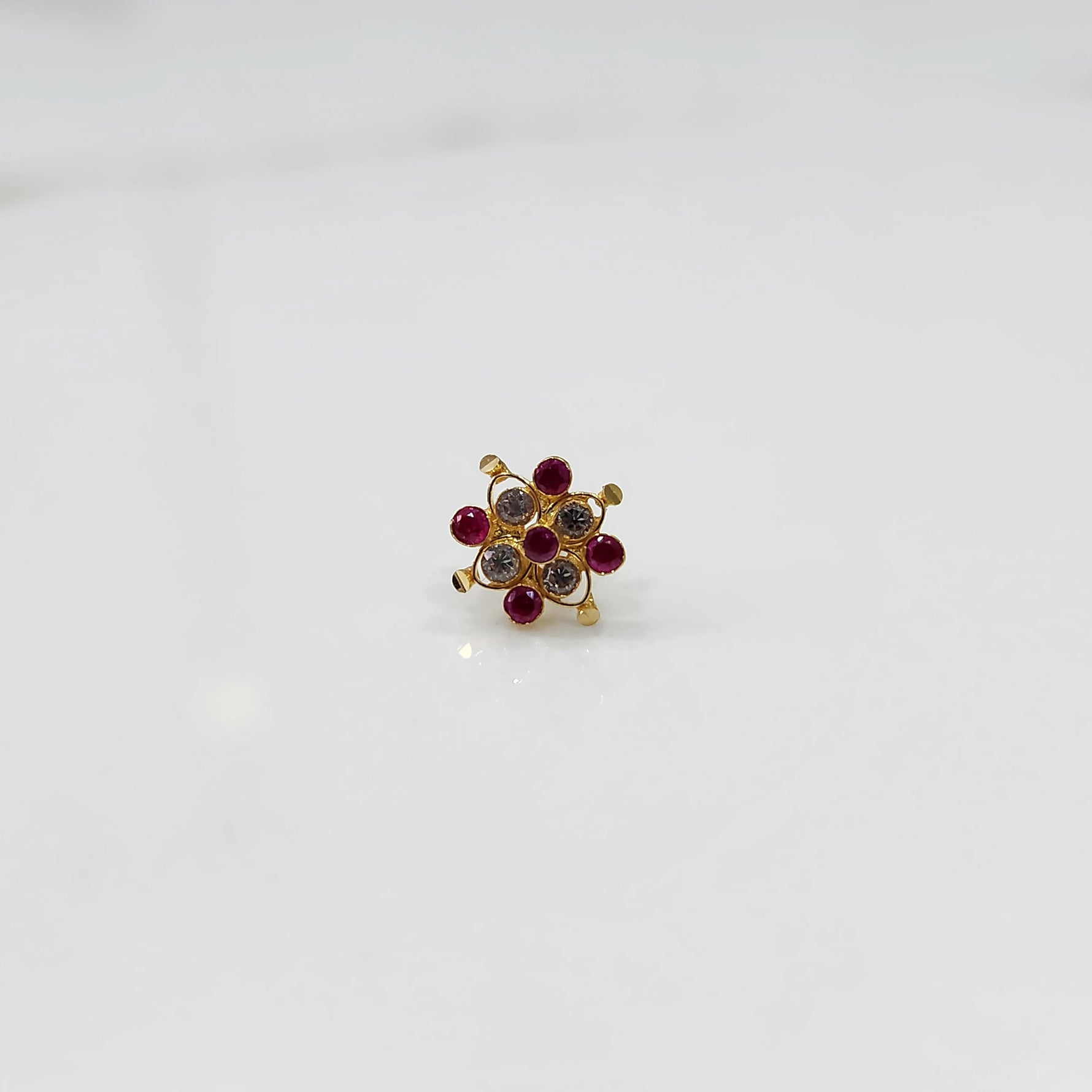 Stone gold nose pin with multicolor stones variation on white background