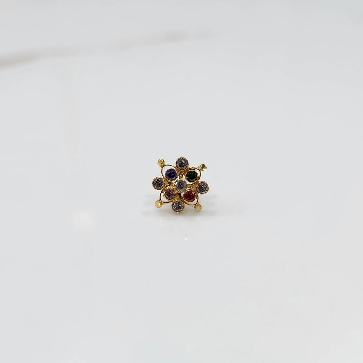 Elegant stone gold nose pin with multi stone cluster