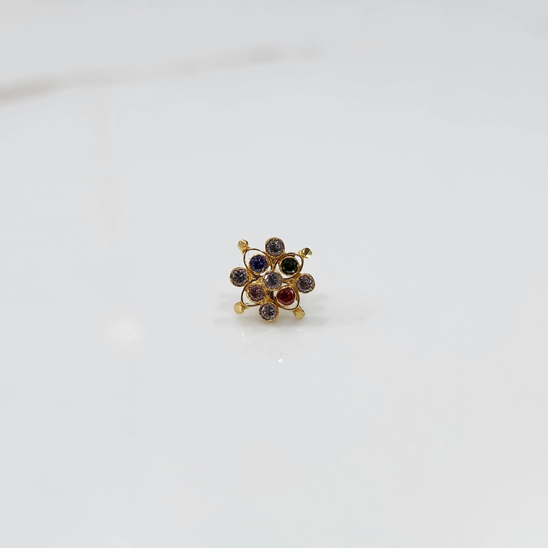 Elegant stone gold nose pin with multi stone cluster