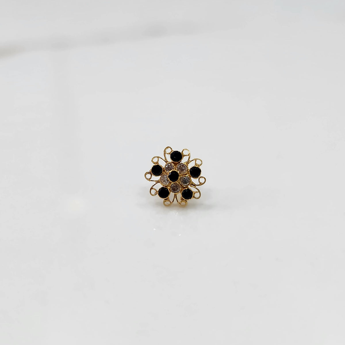 Nose pin new design gold with black stone floral cluster on white background