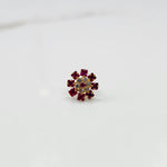Gold nose pin design with red floral stone pattern on white background