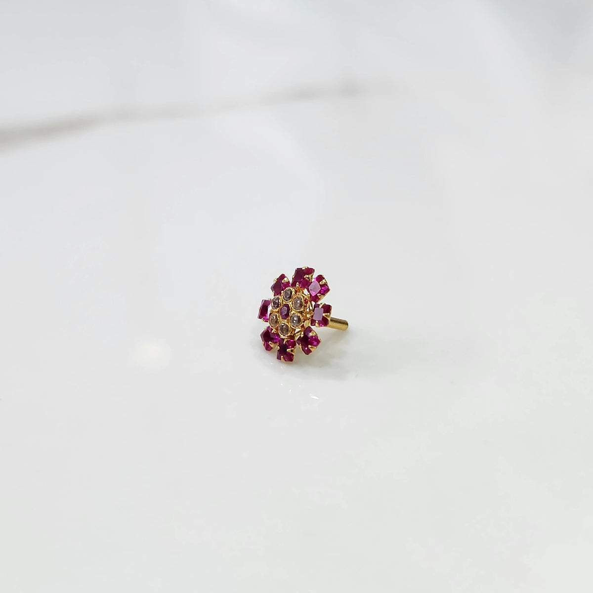 Gold nose pin design with pink gemstone floral cluster