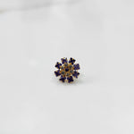 Gold nose pin design with blue floral stone pattern on white background