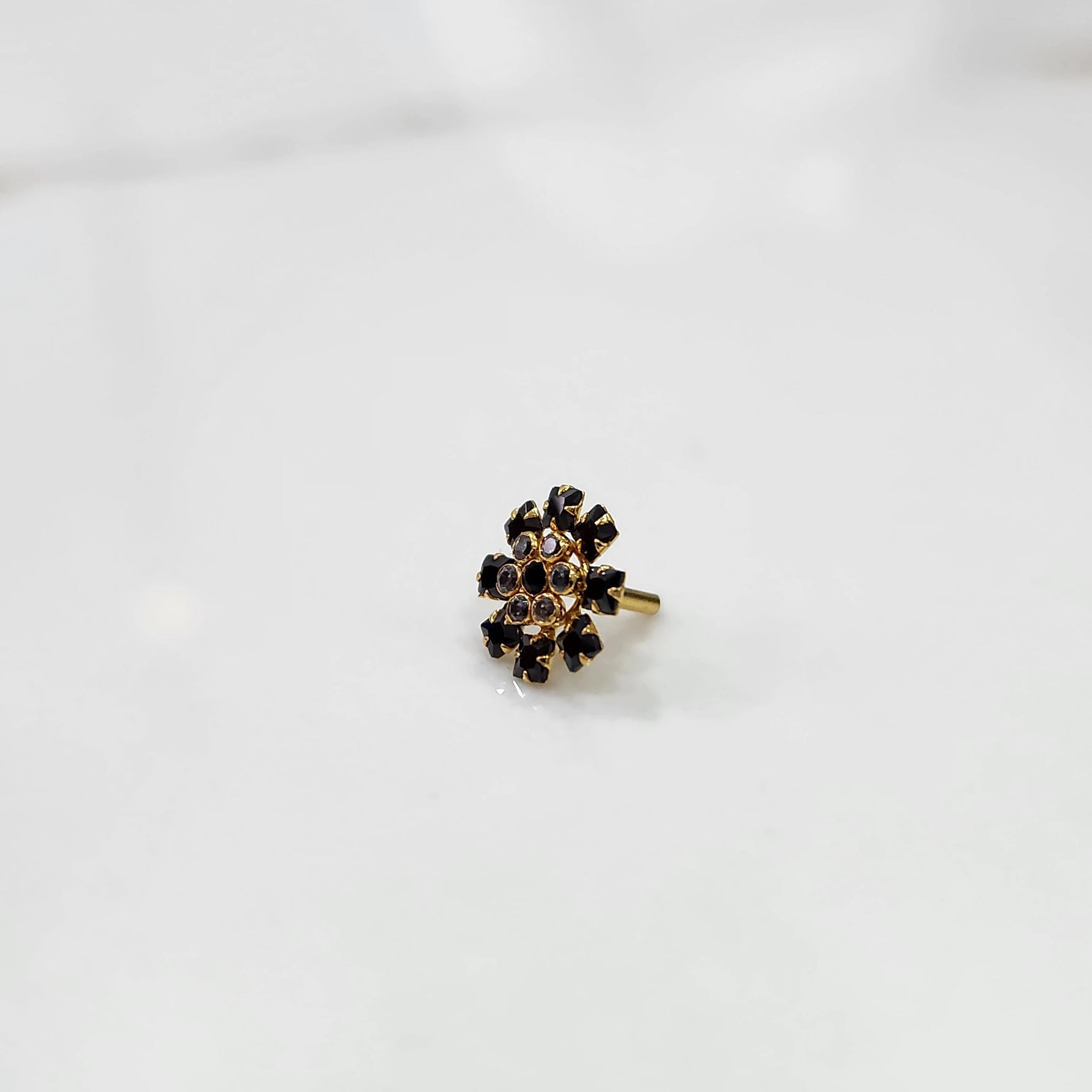 Gold nose pin design with elegant floral cluster angled view