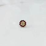 Gold nose pin design with red stone floral pattern on white background