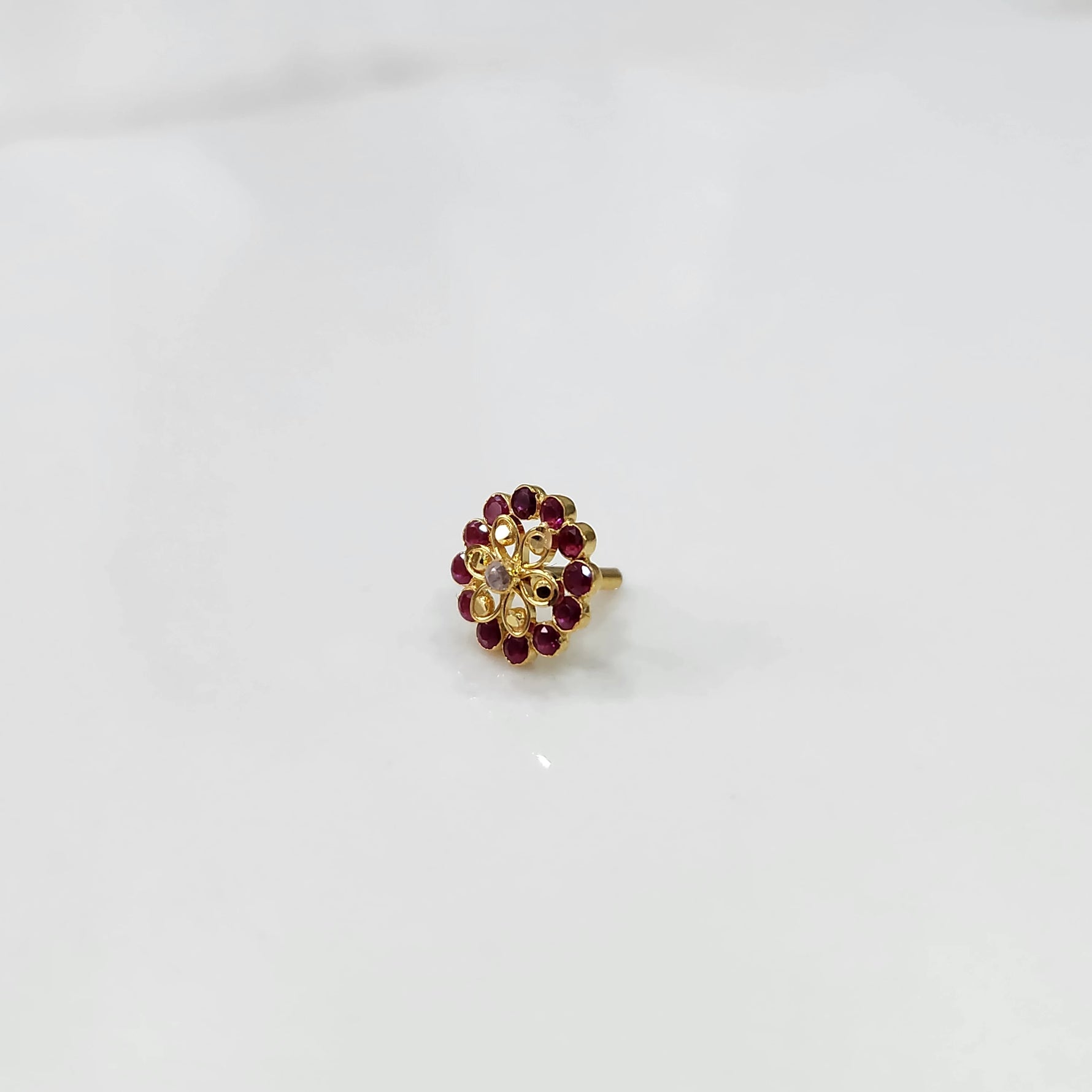 Gold nose pin design with oval red gemstone floral style