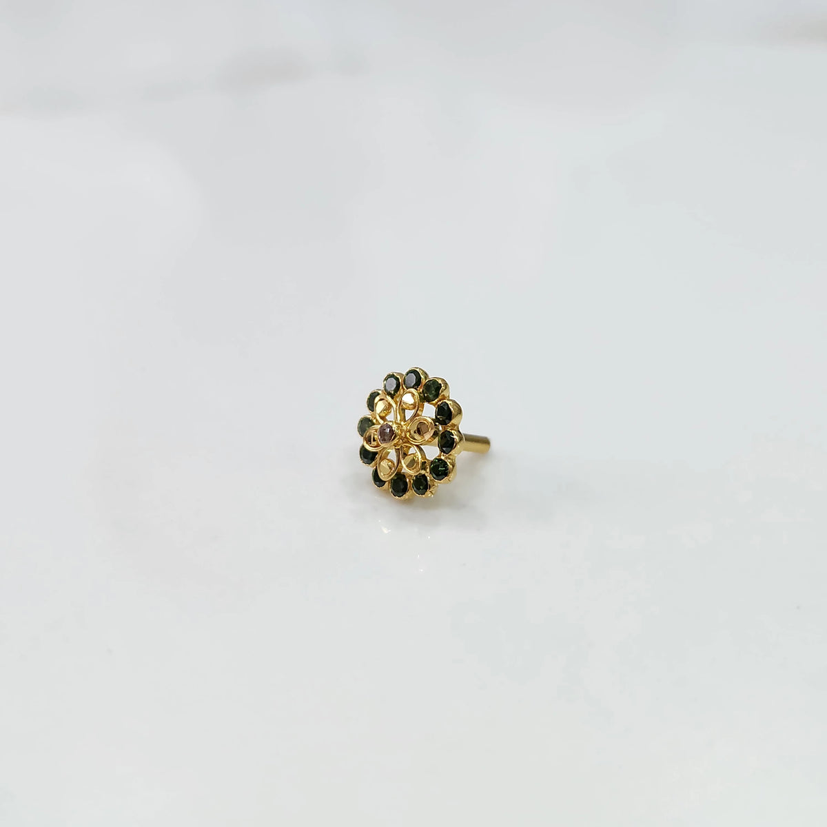 Minimal gold nose pin design with small floral pattern