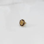 Gold nose pin design with compact floral gemstone setting