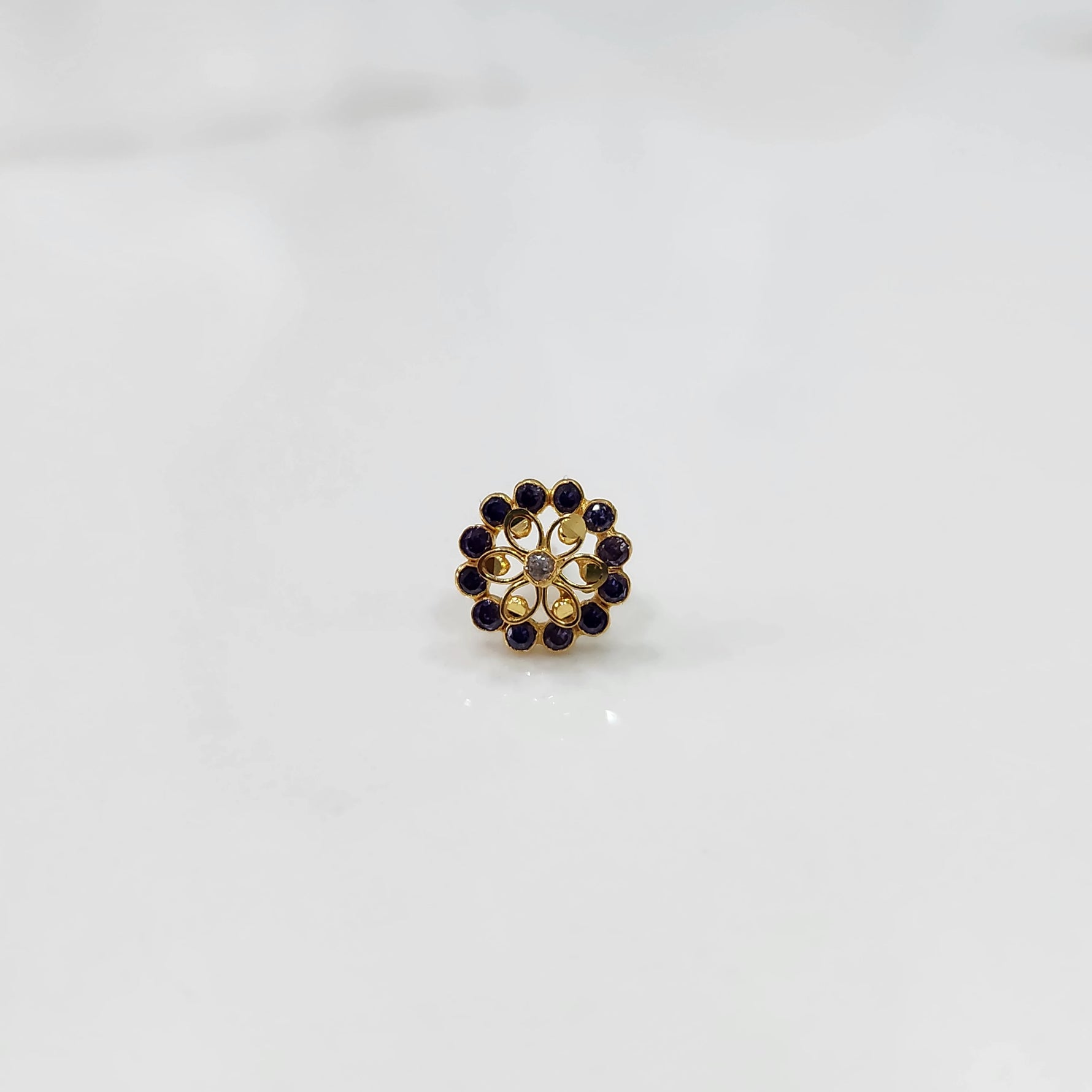 Gold nose pin design with detailed floral diamond arrangement