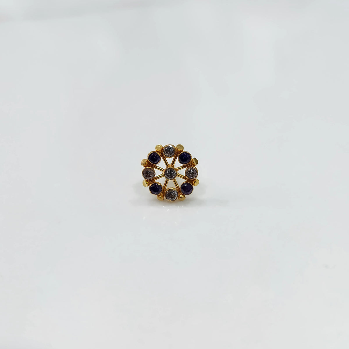 Gold pin nose with multicolor floral cluster on white background