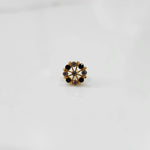 Front view gold pin nose with circular floral stone pattern