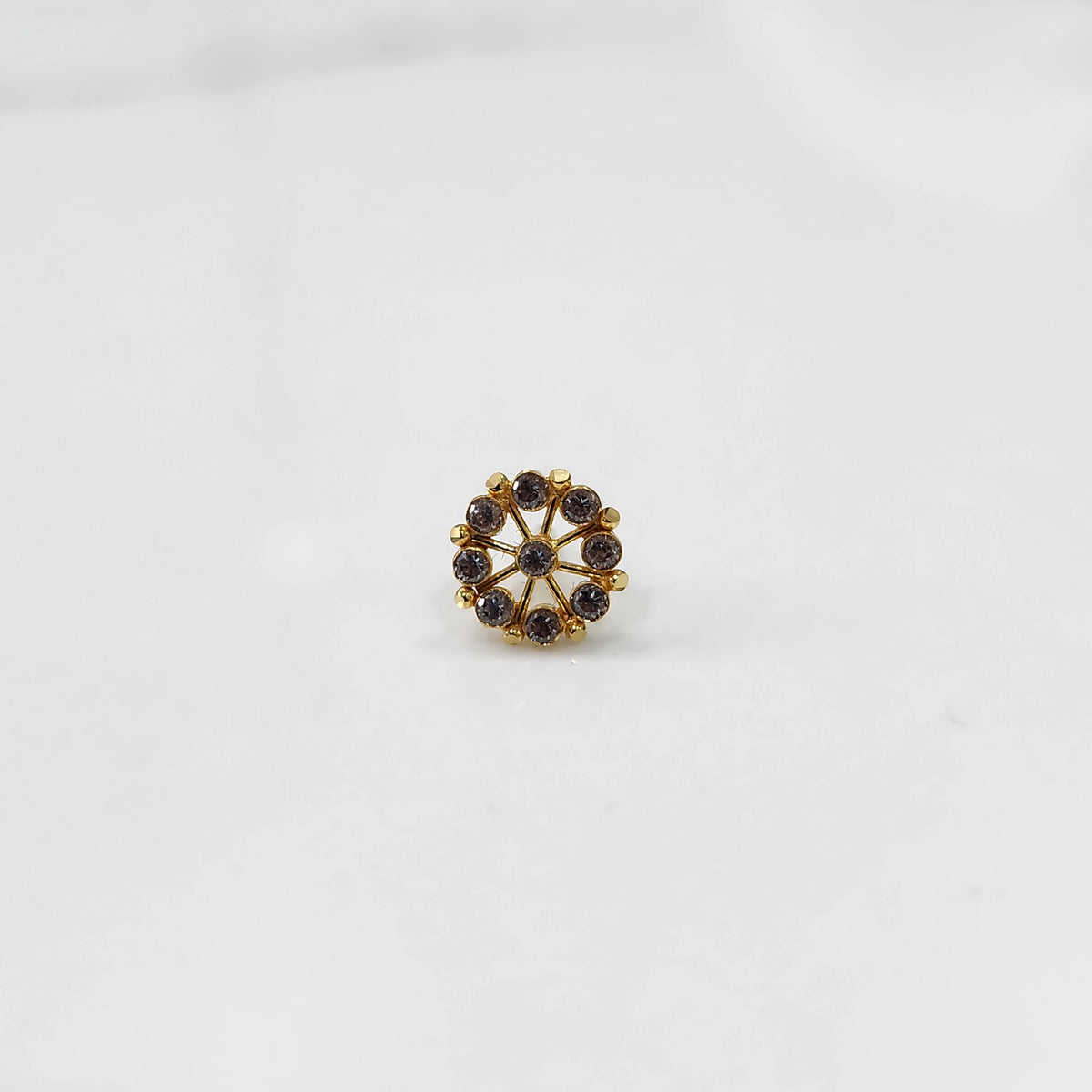 Close up gold pin nose with multicolor floral arrangement