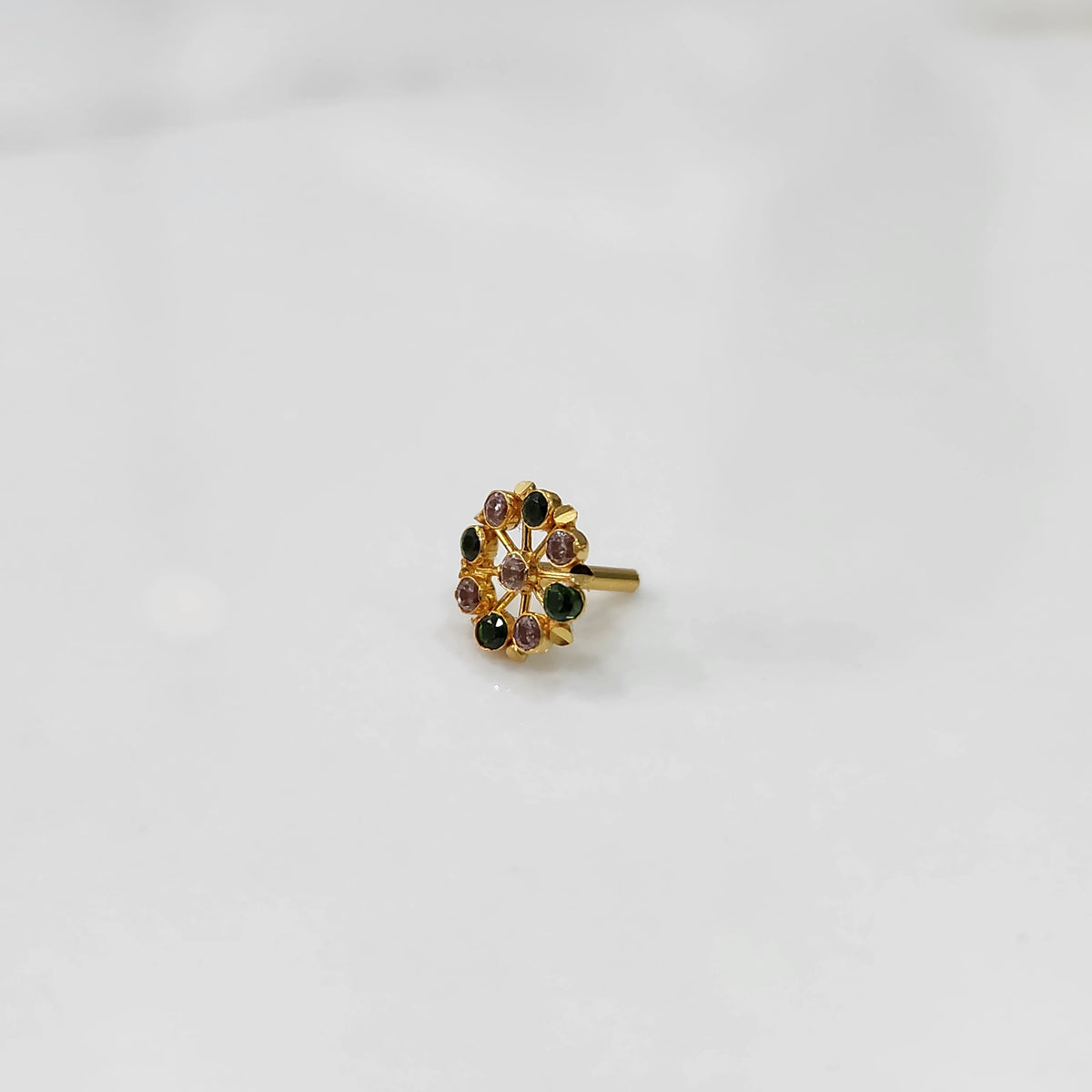 Gold pin nose with compact floral diamond design on white background