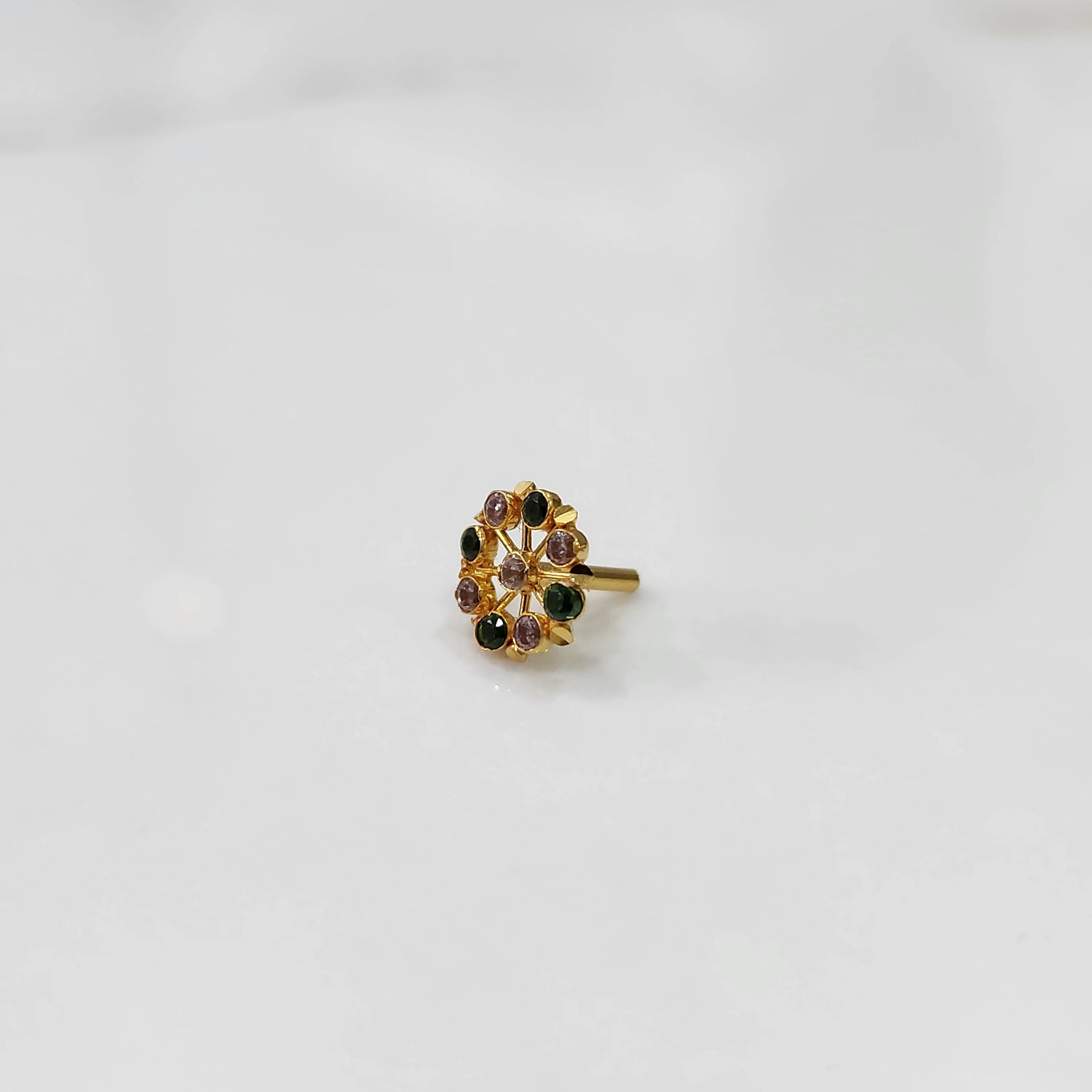 Gold pin nose with compact floral diamond design on white background