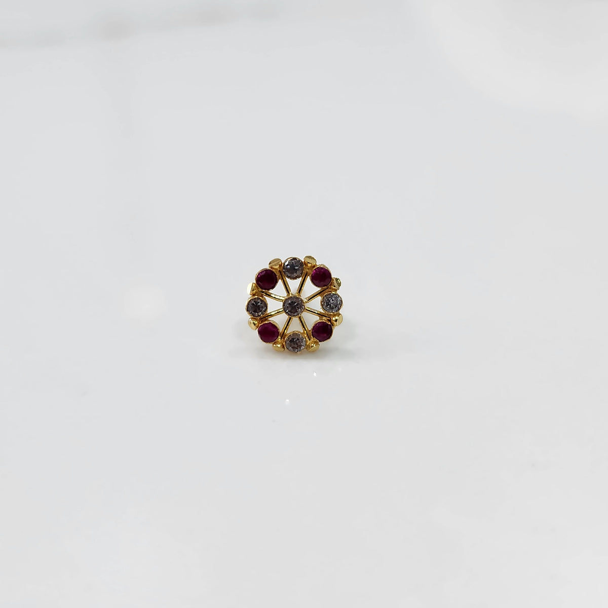 Gold pin nose with elegant floral cluster on white background